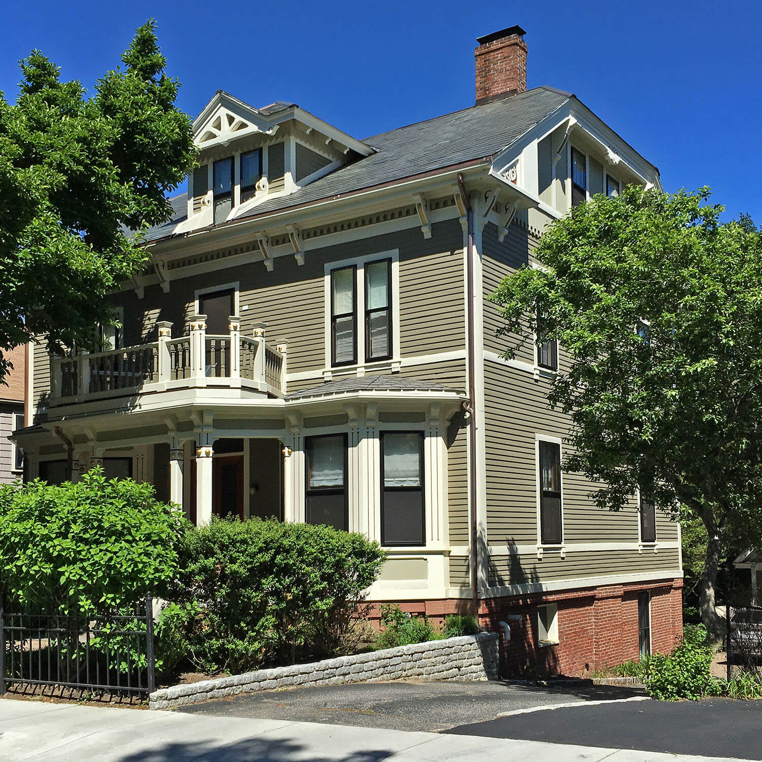 A traditional New England home with gray siding and white trim
